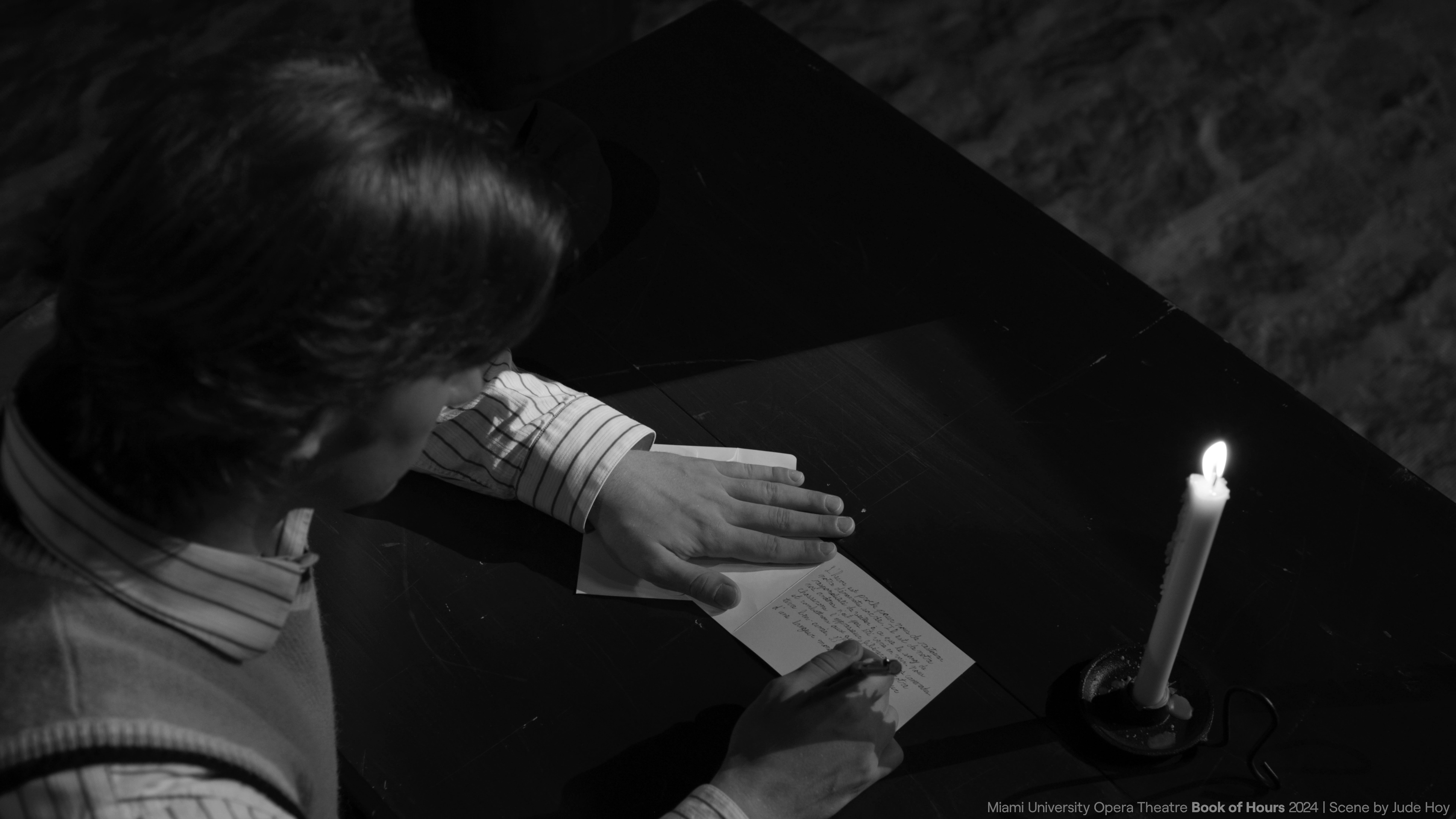 Jacque writing at a desk